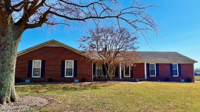 single story home featuring brick siding and a front yard