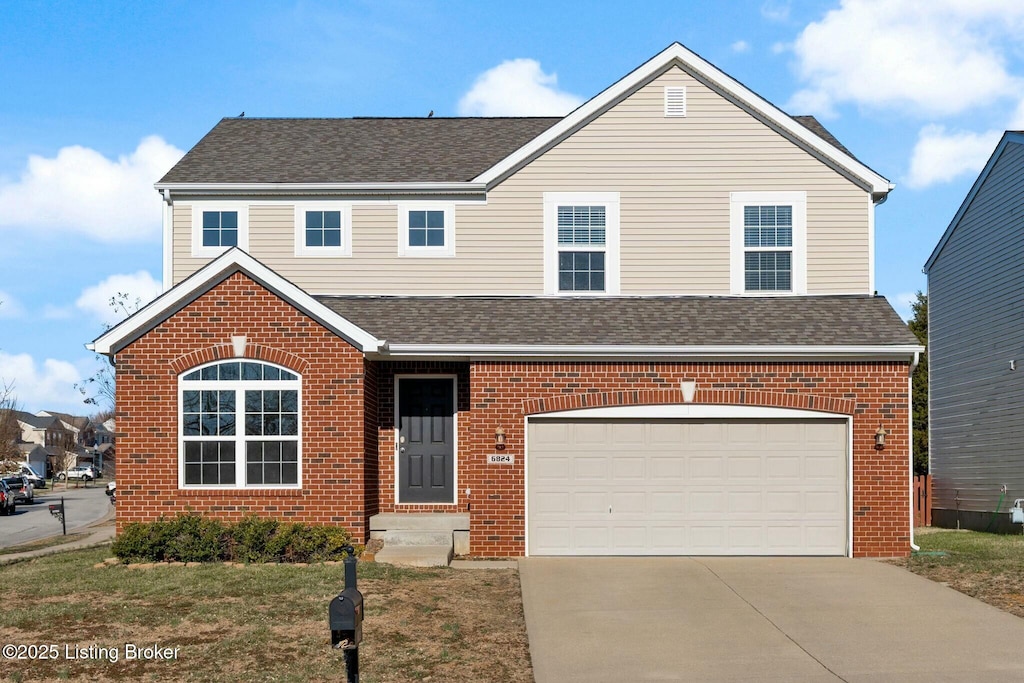 traditional-style house featuring brick siding, driveway, and a shingled roof