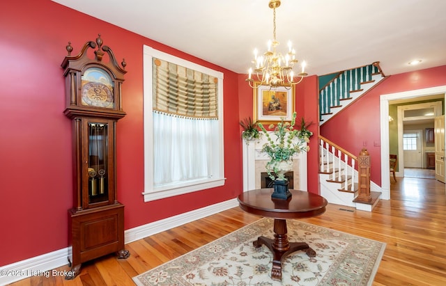 foyer entrance featuring stairway, baseboards, and wood finished floors