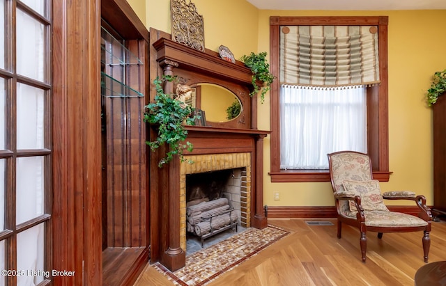 living area with visible vents, baseboards, and a fireplace