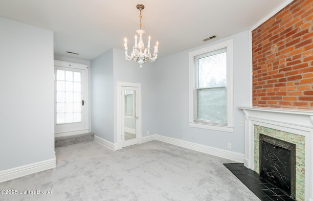 unfurnished living room with a healthy amount of sunlight, carpet, visible vents, and a premium fireplace