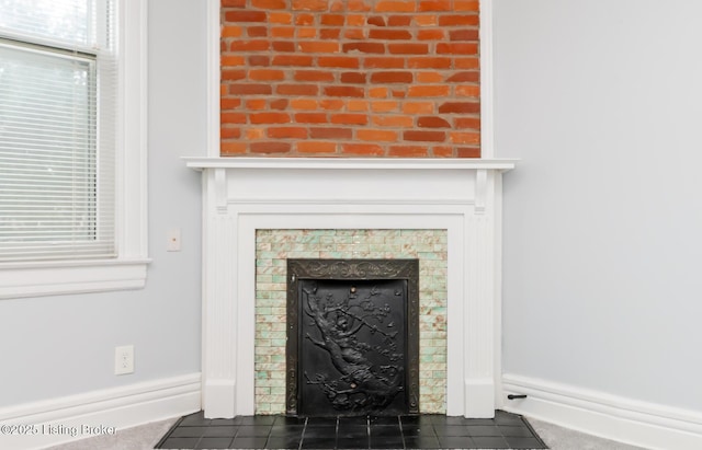 details with a fireplace with flush hearth and baseboards