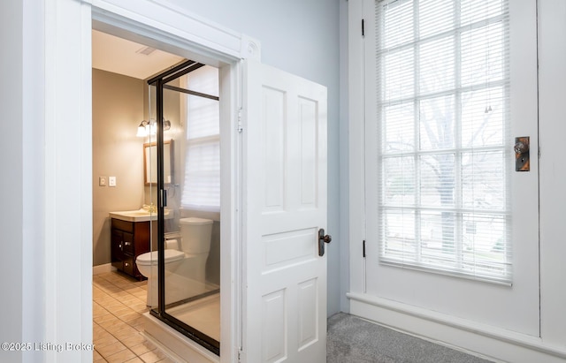 bathroom featuring toilet, vanity, and tile patterned flooring