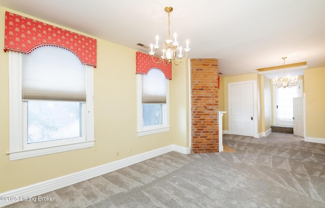 carpeted spare room featuring visible vents, baseboards, and an inviting chandelier