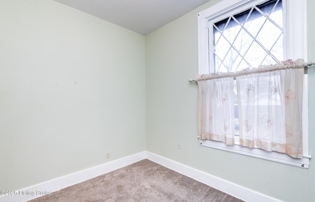 empty room with carpet and baseboards