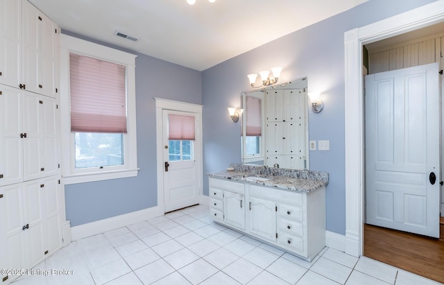 bathroom with visible vents, tile patterned flooring, baseboards, a chandelier, and vanity