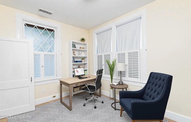 office space with plenty of natural light, baseboards, and visible vents