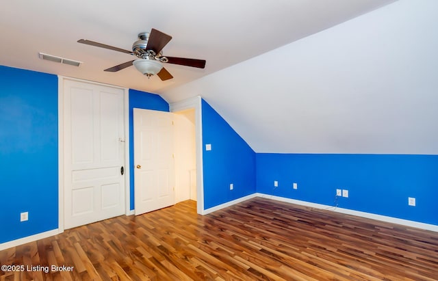 interior space featuring wood finished floors, visible vents, and baseboards