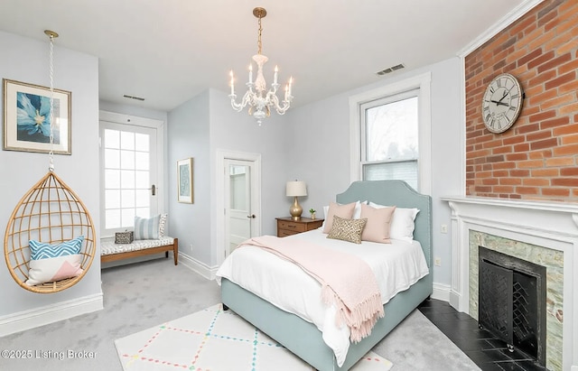 bedroom with a notable chandelier, visible vents, baseboards, and a premium fireplace