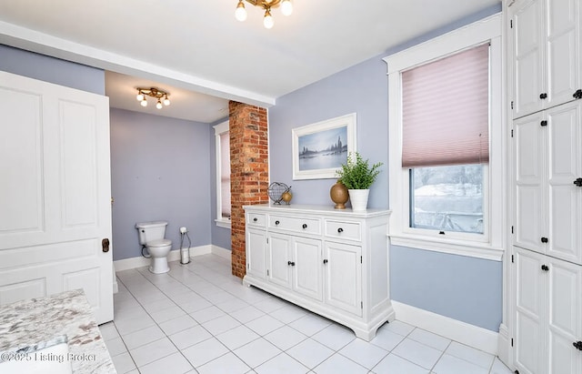 bathroom with vanity, tile patterned floors, toilet, and baseboards