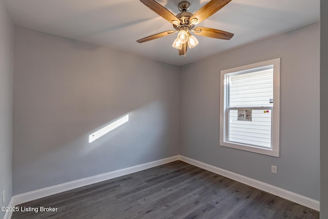 spare room with dark wood-style floors, ceiling fan, and baseboards