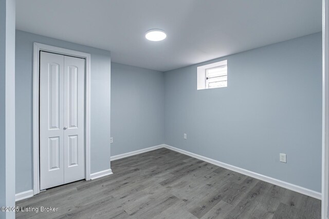 interior space featuring a closet, baseboards, and wood finished floors