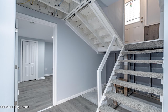 stairs featuring baseboards and wood finished floors