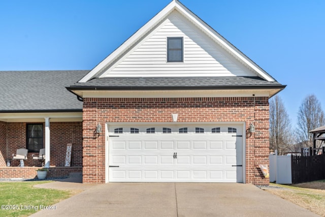 traditional-style home featuring brick siding, a garage, concrete driveway, and roof with shingles