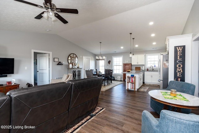 living room featuring lofted ceiling, recessed lighting, dark wood-style floors, and ceiling fan