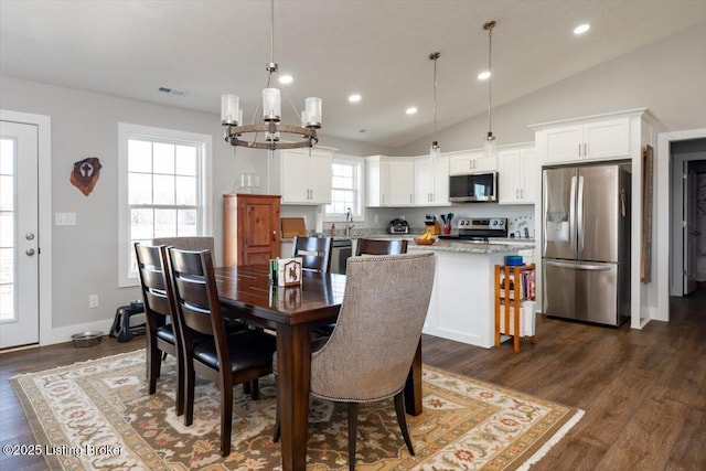 dining area featuring dark wood finished floors, vaulted ceiling, recessed lighting, and visible vents