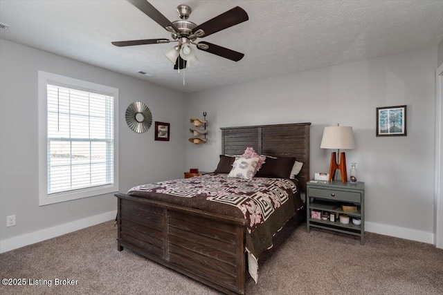 carpeted bedroom featuring visible vents, baseboards, a textured ceiling, and ceiling fan