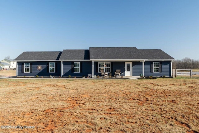 single story home with a front yard and fence