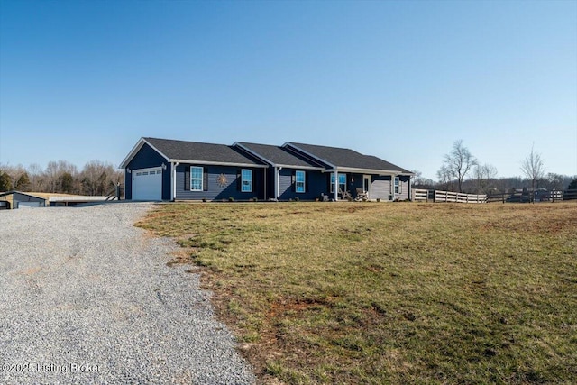 single story home featuring gravel driveway, a front lawn, fence, and a garage