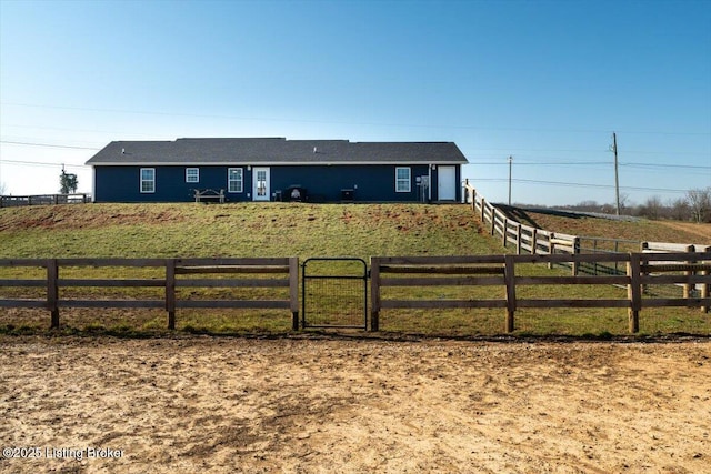 ranch-style home with a fenced front yard and a rural view