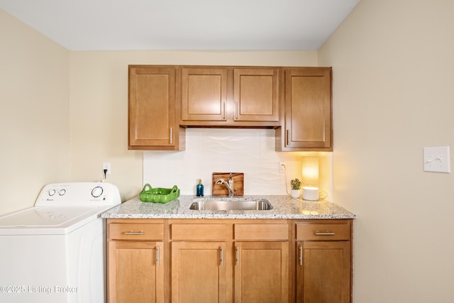 laundry area featuring washer / dryer, cabinet space, and a sink