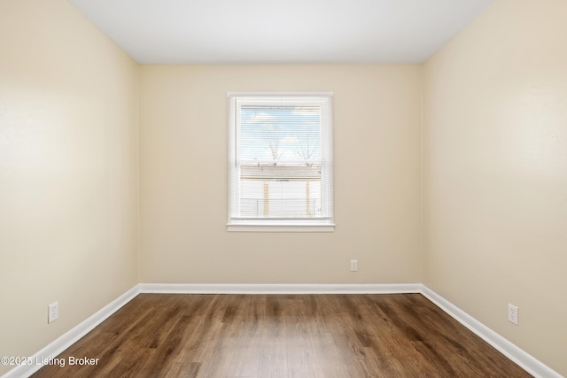 unfurnished room with wood finished floors and baseboards