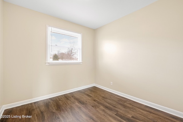 unfurnished room with dark wood-style floors and baseboards