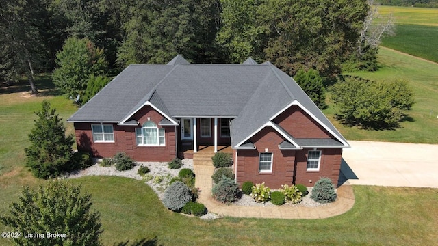 view of front of property featuring a front yard and brick siding