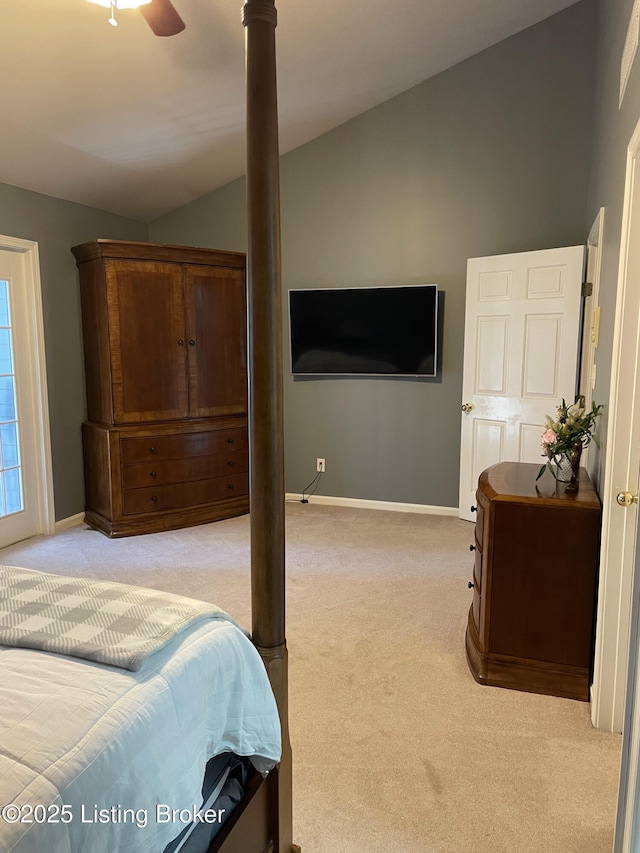 bedroom with light carpet, baseboards, lofted ceiling, and a ceiling fan