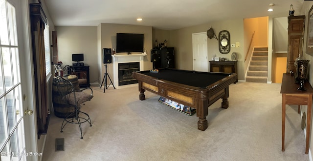 playroom featuring visible vents, light carpet, a glass covered fireplace, and pool table