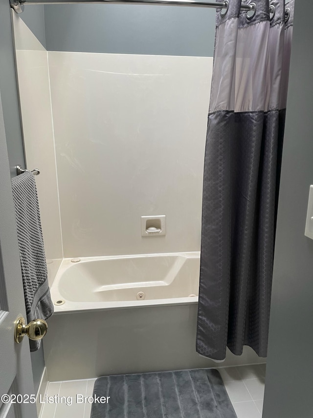 bathroom with shower / bath combo with shower curtain and tile patterned flooring