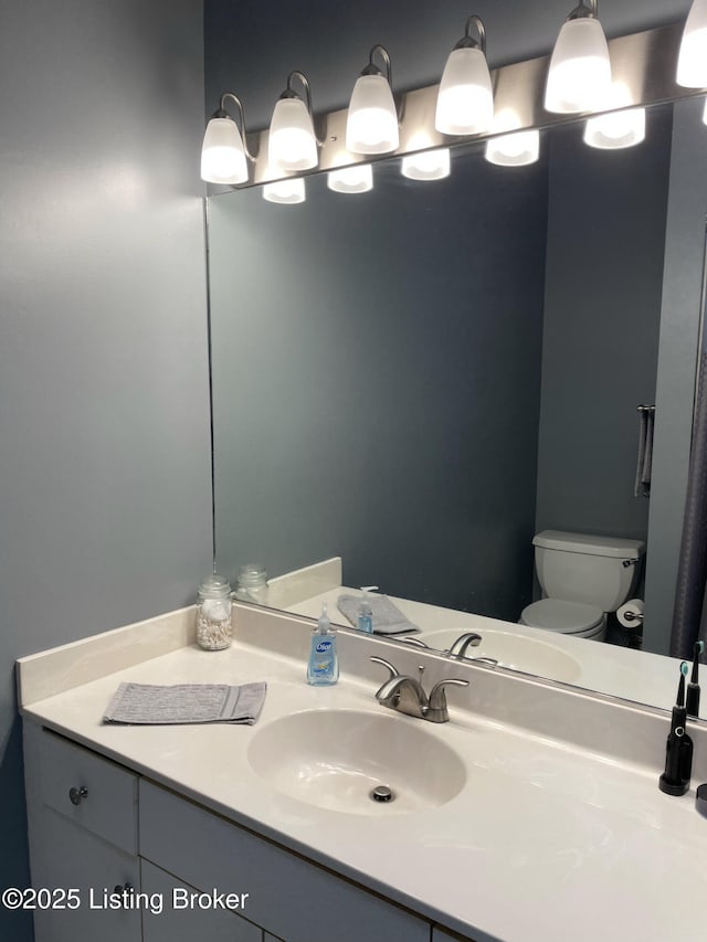 bathroom featuring toilet and vanity