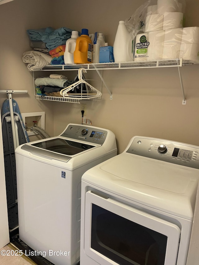 laundry area with washing machine and clothes dryer and laundry area