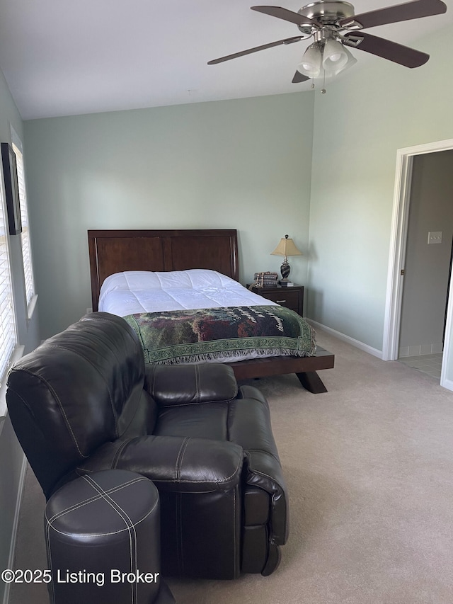 carpeted bedroom featuring baseboards and ceiling fan