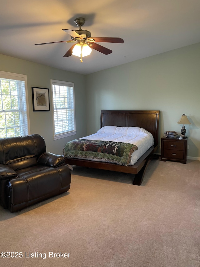 bedroom with multiple windows, a ceiling fan, and carpet