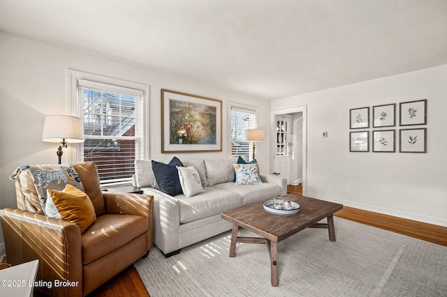 living area with wood finished floors and baseboards