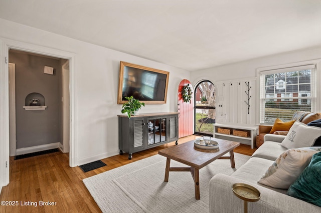 living area featuring baseboards and wood finished floors