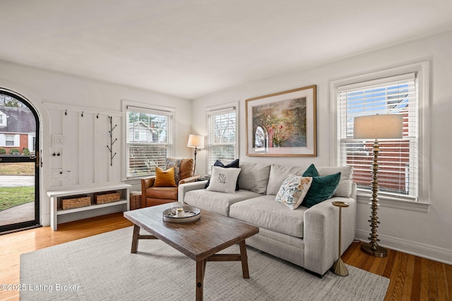 living room featuring baseboards and light wood-style floors