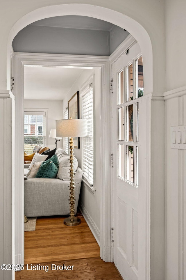 doorway to outside featuring wood finished floors and arched walkways