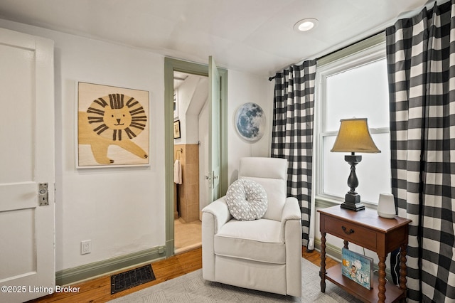 living area with recessed lighting, visible vents, and light wood-style floors