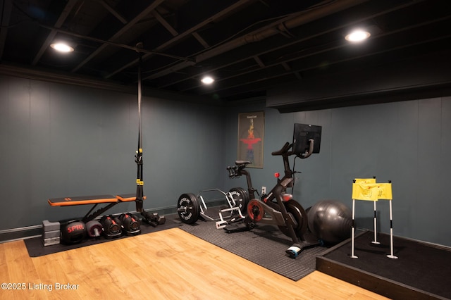 exercise room featuring wood finished floors