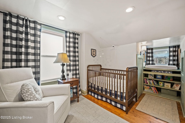 bedroom with recessed lighting, lofted ceiling, and wood finished floors