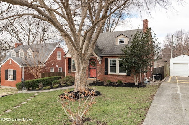 view of front facade featuring central AC unit, fence, an outdoor structure, a front lawn, and brick siding