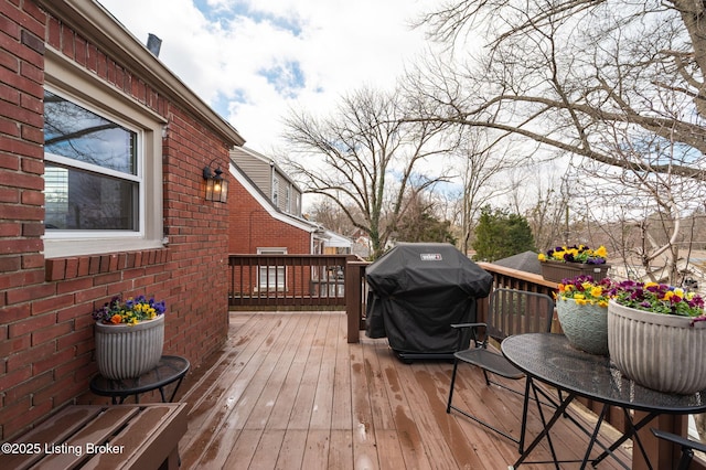 wooden terrace featuring a grill