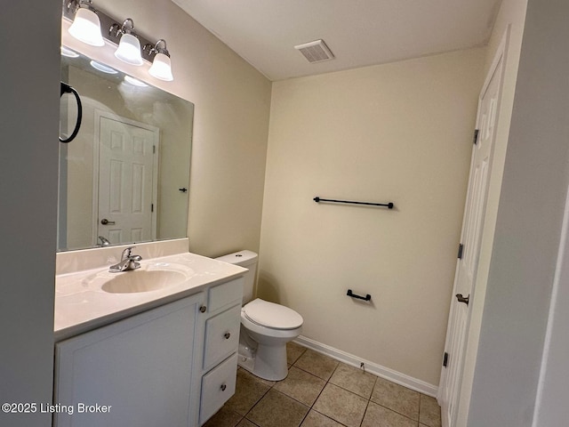 bathroom featuring visible vents, baseboards, toilet, tile patterned floors, and vanity