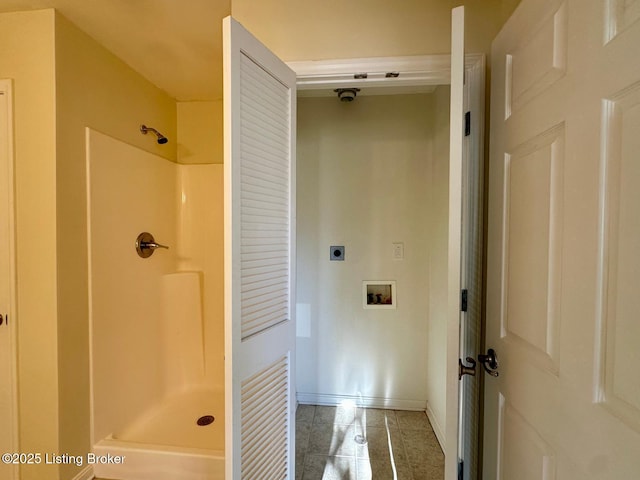 bathroom with tile patterned floors, a shower, and baseboards