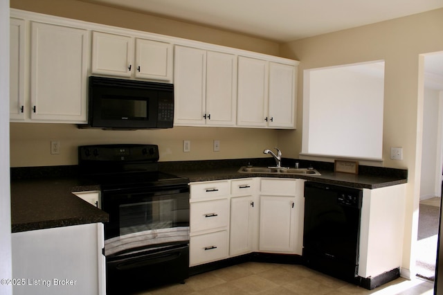 kitchen featuring white cabinetry, black appliances, dark countertops, and a sink