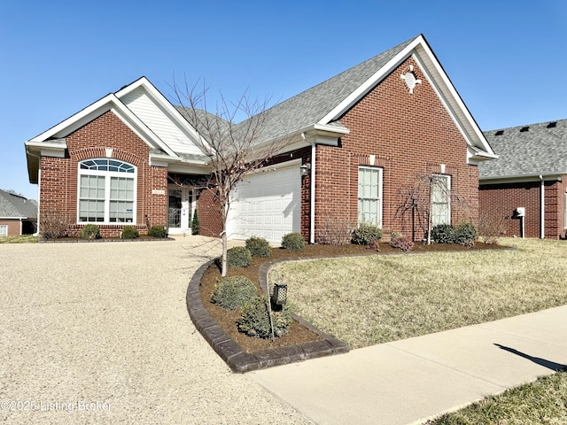 view of front of house with a front lawn, driveway, a shingled roof, a garage, and brick siding