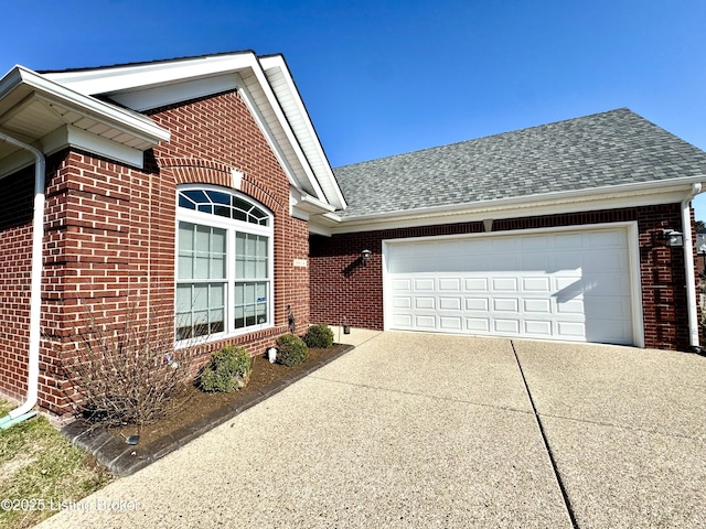 view of front of home with brick siding, an attached garage, concrete driveway, and a shingled roof