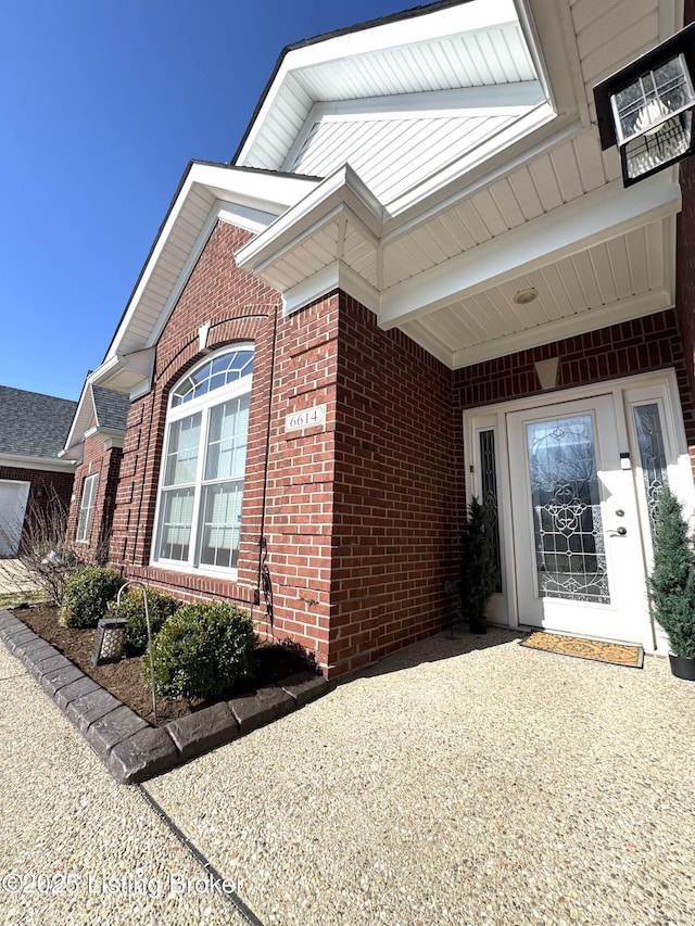 property entrance with brick siding